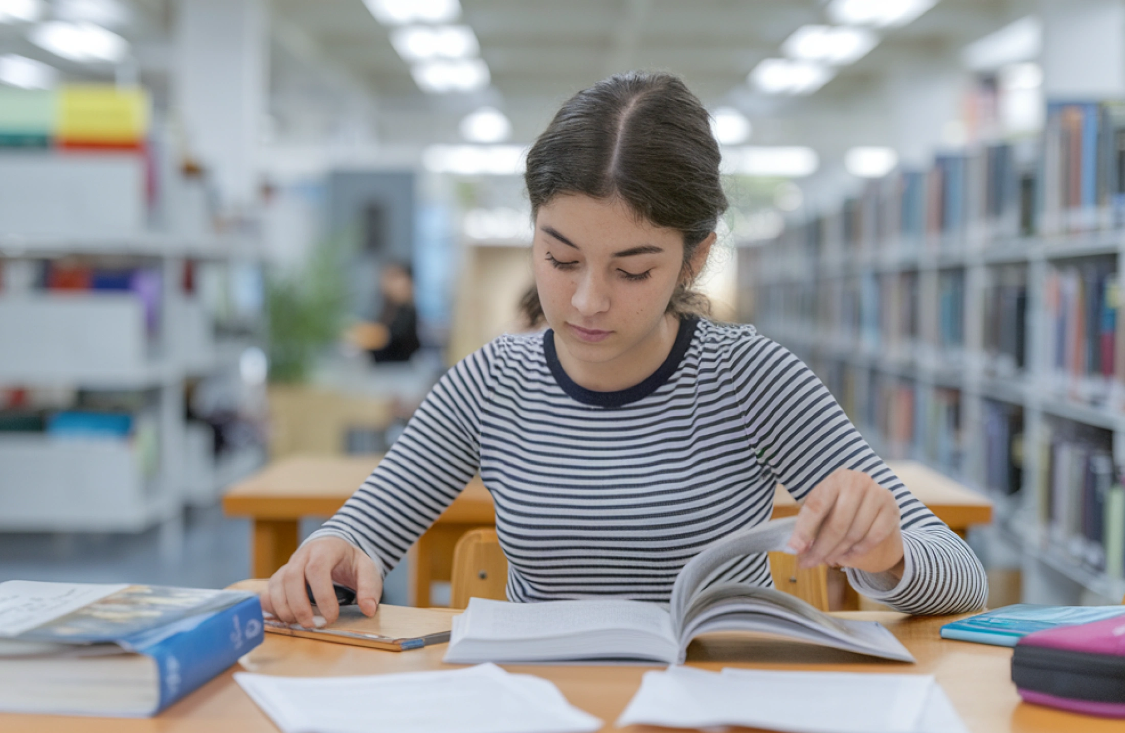 A high school student reading a textbook