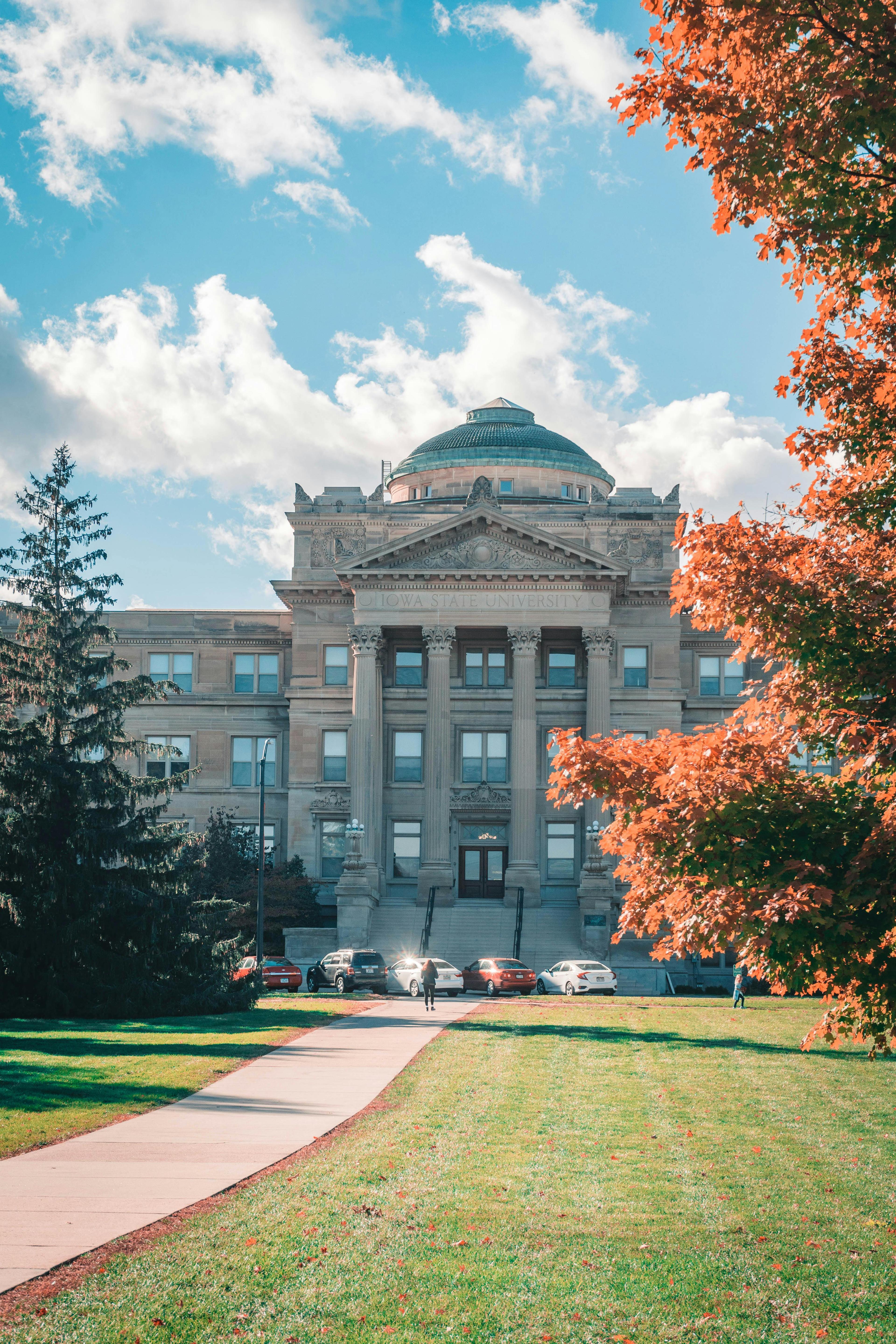 Beardshear Hall on a sunny autumn day with colorful foliage, located at Iowa State University.